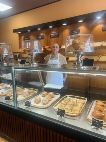 Our baker behind the counter at Just Baked Bakery