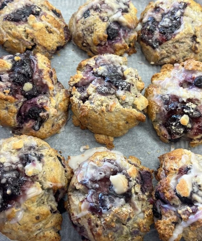 Freshly baked glazed blueberry crumble muffins