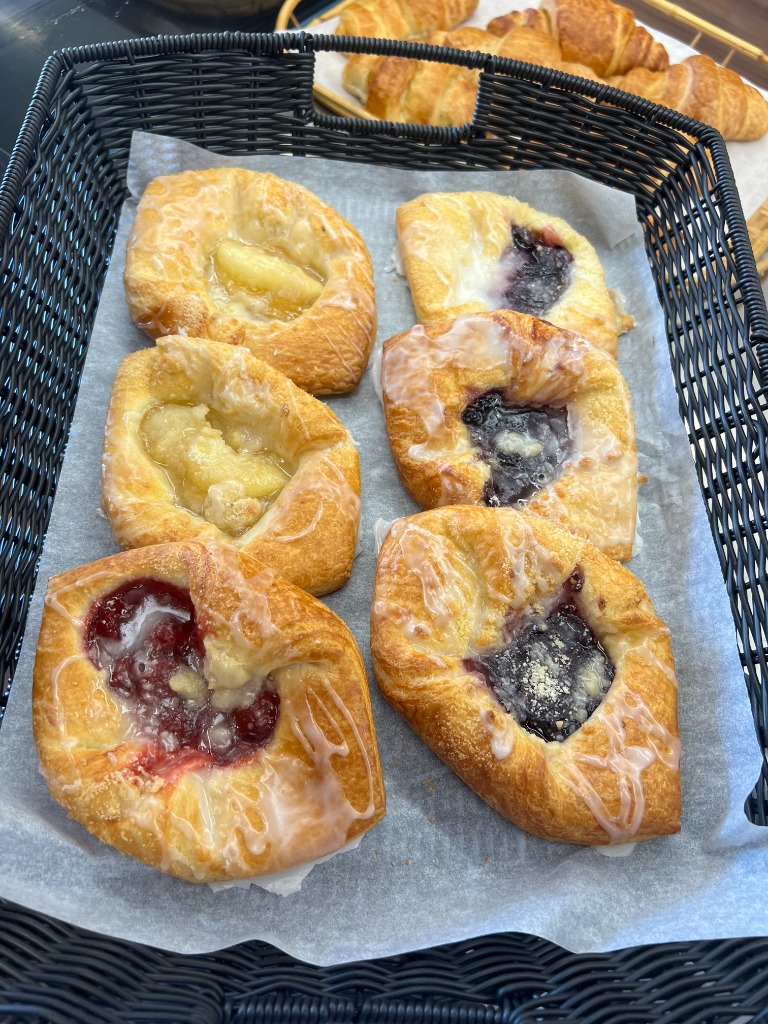 Assortment of freshly baked glazed fruit danish pastries